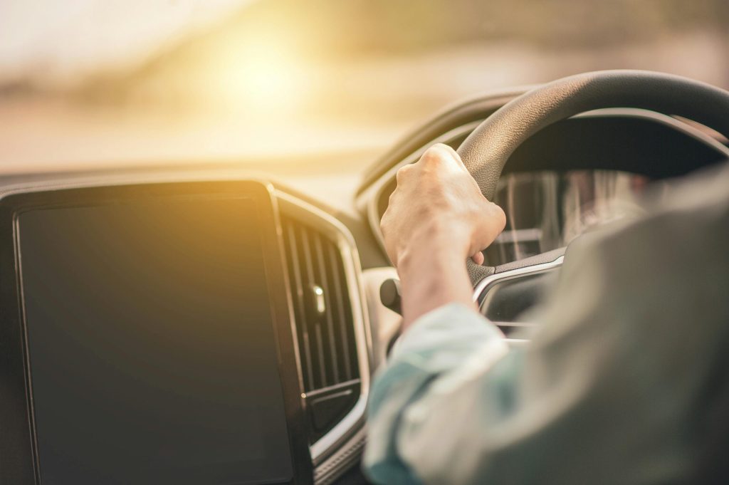 Hands holding steering wheel